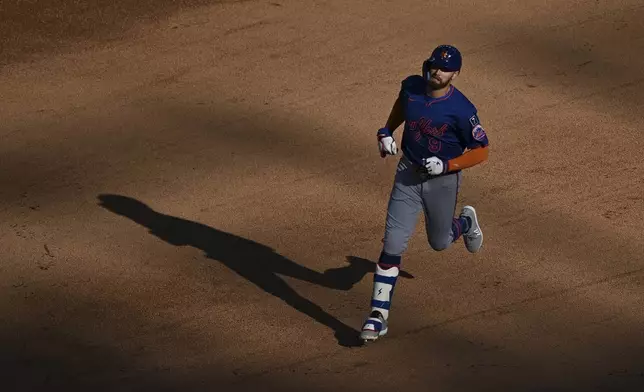 New York Mets' Brandon Nimmo runs the bases after hitting a three-run home run off Washington Nationals pitcher Colin Poche during the sixth inning of a baseball game in Washington, Monday, April 28, 2025. (AP Photo/Terrance Williams)
