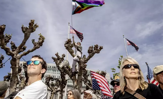Demonstrators rally in Civic Center Plaza in San Francisco, on Saturday, April 5, 2025, during a protest against President Donald Trump, part of the "Hands Off" rallies held nationwide. (Stephen Lam/San Francisco Chronicle via AP)