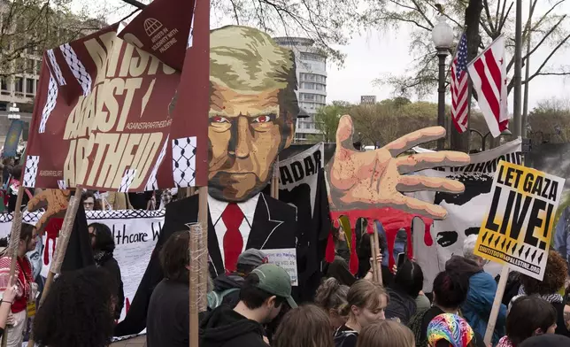 Pro-Palestinian protesters carrying a depiction of President Donald Trump gather at a rally before marching toward the U.S. Immigration and Customs Enforcement (ICE) headquarters, Saturday, April 5, 2025, in Washington. (AP Photo/Manuel Balce Ceneta)