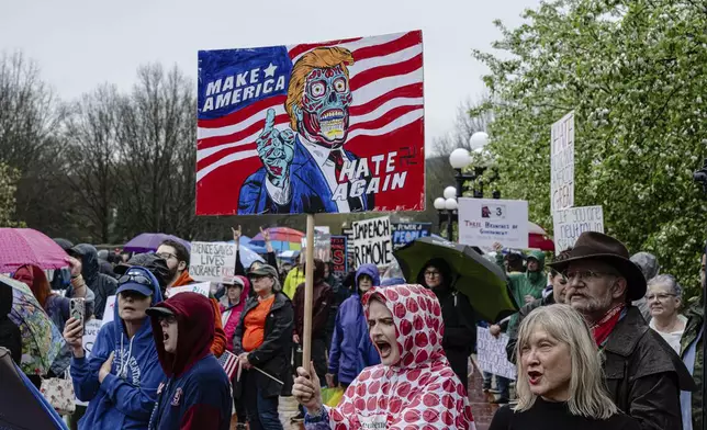 Protesters shout during a "Hands Off!" protest against President Donald Trump on the grounds of the Kentucky Capitol, Saturday, April 5, 2025, in Frankfort, Ky. (AP Photo/Jon Cherry)