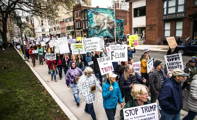 Demonstrators hold a rally at the Pennsylvania state capitol in Harrisburg, Pa., during the "Hands Off!" national day of protest against the Trump Administration on Saturday, April 5, 2025. (Zach Gleiter/The Patriot-News via AP)