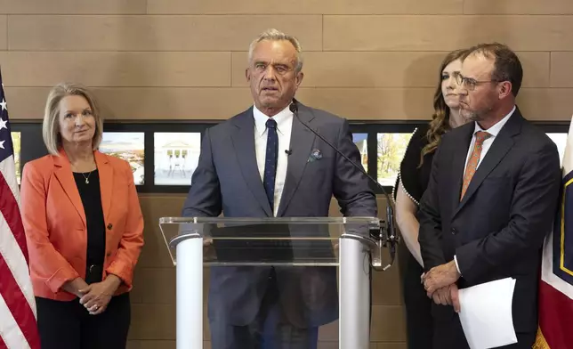 Health and Human Services Secretary Robert F. Kennedy Jr., center, speaks during a press conference about Utah's new fluoride ban, food additives and SNAP funds legislation, Monday, April 7, 2025, in Salt Lake City. (AP Photo/Melissa Majchrzak)