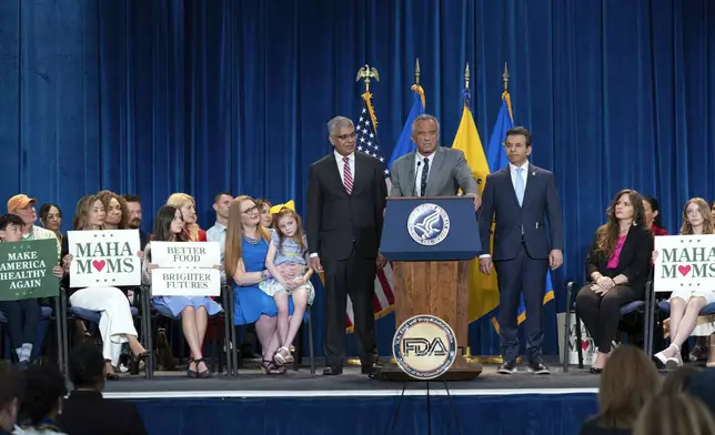 Health and Human Services Secretary Robert F. Kennedy Jr. flanked by Director of the National Institutes of Health Jay Bhattacharya, left, and Food and Drug Administration (FDA) commissioner Marty Makary, right, speaks during a news conference on the FDA's intent to phase out the use of petroleum-based synthetic dyes in the nation's food supply at the Hubert Humphrey Building Auditorium in Washington, Tuesday, April 22, 2025. (AP Photo/Jose Luis Magana)