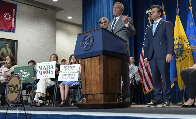 Health and Human Services Secretary Robert F. Kennedy Jr. flanked by Director of the National Institutes of Health Jay Bhattacharya, left, and Food and Drug Administration (FDA) commissioner Marty Makary, right, speaks during a news conference on the FDA's intent to phase out the use of petroleum-based synthetic dyes in the nation's food supply at the Hubert Humphrey Building Auditorium in Washington, Tuesday, April 22, 2025. (AP Photo/Jose Luis Magana)