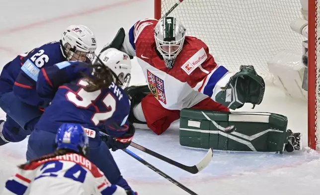 United States' Kendall Coyne Schofield (26) skates in as teammate Abbey Murphy (37) scores on Czech Republic goalkeeper Michaela Hesova during a Group A match at the women's world ice hockey championships, Friday, April 11, 2025, in Ceske Budejovice, Czech Republic. (Vaclav Pancer/CTK via AP)