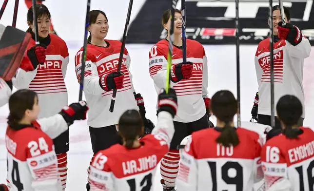 Japanese players celebrate their victory after the IIHF Women's World Championship, Group B, match between Hungary and Japan, in Ceske Budejovice, Czech Republic, Friday, April 11, 2025. (Vaclav Pancer/CTK via AP)