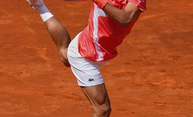 Novak Djokovic of Serbia returns the ball against Matteo Arnaldi of Italy during the Madrid Open tennis tournament in Madrid, Spain, Saturday, April 26, 2025. (AP Photo/Manu Fernandez)