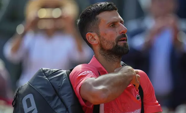 Novak Djokovic of Serbia leaves the court after losing against Matteo Arnaldi of Italy during the Madrid Open tennis tournament in Madrid, Spain, Saturday, April 26, 2025. (AP Photo/Manu Fernandez)