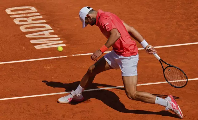 Novak Djokovic of Serbia competes against Matteo Arnaldi of Italy during the Madrid Open tennis tournament in Madrid, Spain, Saturday, April 26, 2025. (AP Photo/Manu Fernandez)