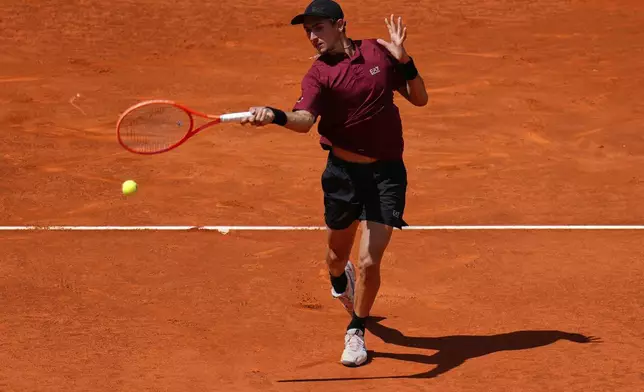 Matteo Arnaldi of Italy returns the ball against Novak Djokovic of Serbia during the Madrid Open tennis tournament in Madrid, Spain, Saturday, April 26, 2025. (AP Photo/Manu Fernandez)