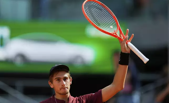 Matteo Arnaldi of Italy celebrates after his victory over Novak Djokovic of Serbia during the Madrid Open tennis tournament in Madrid, Spain, Saturday, April 26, 2025. (AP Photo/Manu Fernandez)