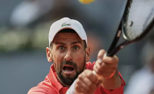 Novak Djokovic of Serbia serves against Matteo Arnaldi of Italy during the Madrid Open tennis tournament in Madrid, Spain, Saturday, April 26, 2025. (AP Photo/Manu Fernandez)