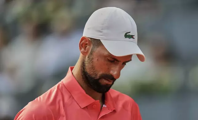 Novak Djokovic of Serbia reacts during his match against Matteo Arnaldi of Italy during the Madrid Open tennis tournament in Madrid, Spain, Saturday, April 26, 2025. (AP Photo/Manu Fernandez)