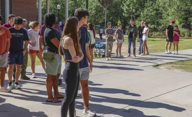 Students wait to retrieve their personal items from the Florida State Student Union building, Tallahassee, Fla., Friday, April 18, 2025. (AP Photo/Gary McCullough)