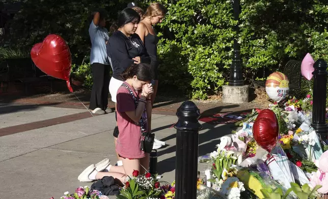 Students gather on a stretch of sidewalk near the center of the Florida State campus in sight of the Student Union building, Tallahassee, Fla., Friday, April 18, 2025. (AP Photo/Gary McCullough)