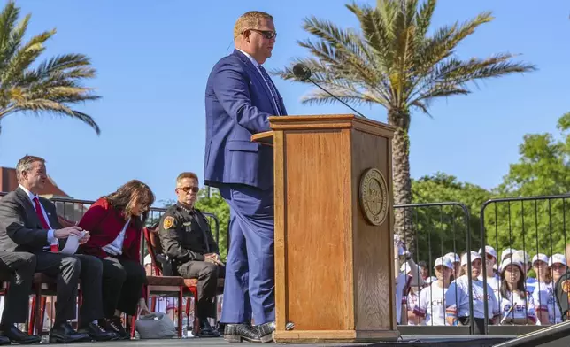 The day after an active shooter on campus Florida State senior vice president Kyle Clark addresses a vigil on campus at Langford Green, Tallahassee, Fla., Friday, April 18, 2025. (AP Photo/Gary McCullough)