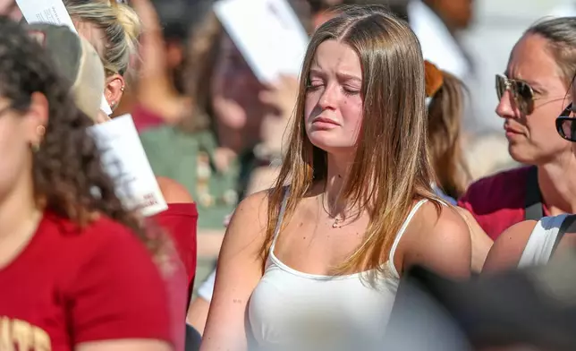 A student mourns during a vigil on the Florida State campus at Langford Green, Tallahassee, Fla., Friday, April 18, 2025. (AP Photo/Gary McCullough)