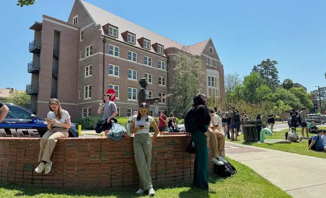 Florida State University students wait for news amid an active shooter incident at the school’s campus in Tallahassee, Fla., Thursday, April 17, 2025 (AP Photo/Kate Payne)