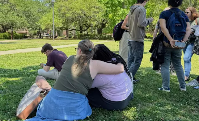 People comfort each other on Florida State University’s campus in Tallahassee, where law enforcement responded to a reported active shooter incident Thursday, April 17, 2025. (AP Photo/Kate Payne)