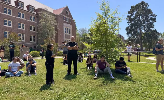 Florida State University students wait for news amid an active shooter incident at the school’s campus in Tallahassee, Fla., Thursday, April 17, 2025 (AP Photo/Kate Payne)