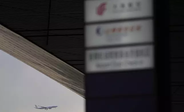 An Air China passenger jet prepares to land at the Capital International Airport Terminal 3 as gale wind alerts cancelled flights in Beijing, China, Saturday, April 12, 2025. (AP Photo/Ng Han Guan)
