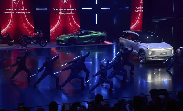 Performers take part in the Volkswagen Group media night ahead of the Auto Show in Shanghai, Tuesday, April 22, 2025. (AP Photo/Ng Han Guan)