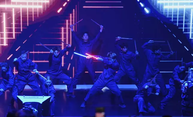 Performers take part in the Volkswagen Group media night ahead of the Auto Show in Shanghai, Tuesday, April 22, 2025. (AP Photo/Ng Han Guan)