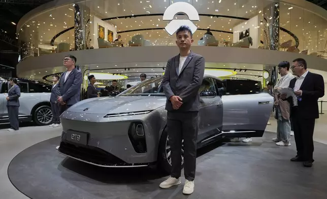 Staff from Chinese automaker Nio waits for visitors at their booth during the Shanghai auto show on Wednesday, April 23, 2025. (AP Photo/Ng Han Guan)