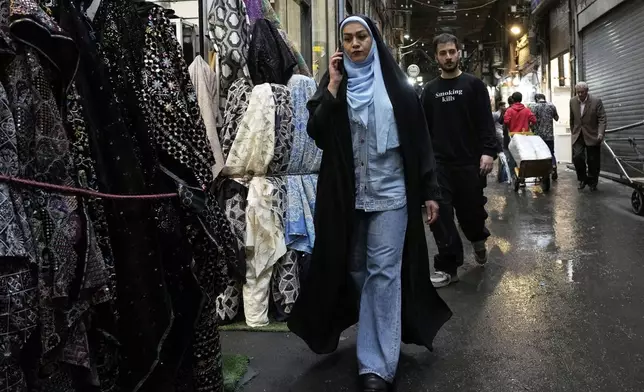 People walk through the old grand bazaar of Tehran, Iran, Saturday, April 5, 2025. (AP Photo/Vahid Salemi)