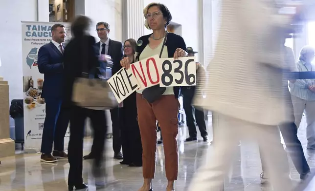 Rina Belmont protests an immigration bill outside the Senate chamber at the state Capitol Thursday, April 10, 2025 in Nashville, Tenn. (AP Photo/John Amis)