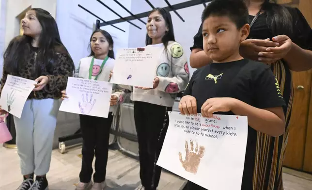 Adalid Lopez, 7, and friends attend a protest against an immigration bill outside the Senate chamber at the state Capitol Thursday, April 10, 2025 in Nashville, Tenn. (AP Photo/John Amis)