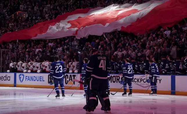 The Toronto Maple Leafs stand during the Canadian national anthem before first period NHL playoff action against the Ottawa Senators, in Toronto on Sunday April 20, 2025. (Frank Gunn/The Canadian Press via AP)