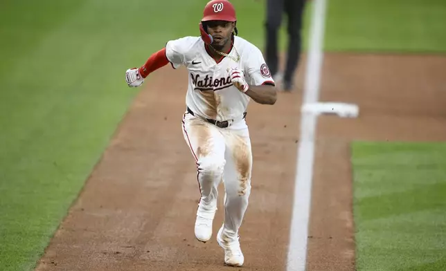 Washington Nationals' Jose Tena runs towards home plate to score on a wild pitch by Baltimore Orioles starting pitcher Dean Kremer during the second inning of a baseball game, Tuesday, April 22, 2025, in Washington. (AP Photo/Nick Wass)