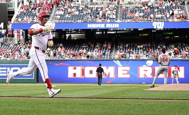 Washington Nationals' Nathaniel Lowe celebrates his two-run home run during the first inning of a baseball game against the Baltimore Orioles, Tuesday, April 22, 2025, in Washington. (AP Photo/Nick Wass)