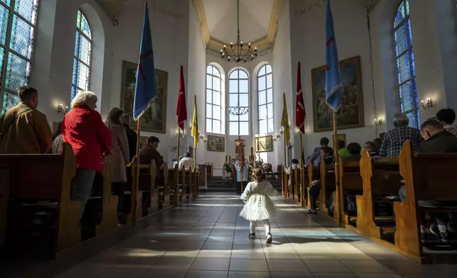 Ukrainian Roman Catholic believers celebrate Easter in a cathedral in Kropyvnytskyi, Ukraine, Sunday, April 20, 2025. (AP Photo/Dan Bashakov)