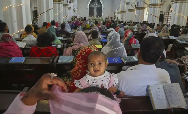 Christians attend an Easter Mass at the St. John's Cathedral, in Peshawar, Pakistan, Sunday, April 20, 2025. (AP Photo/Muhammad Sajjad)