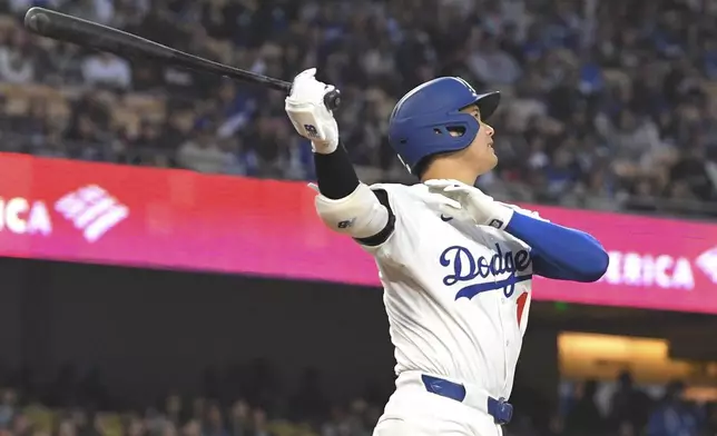 Los Angeles Dodgers' Shohei Ohtani watches his ball go out for a solo home run during the first inning of a baseball game against the Colorado Rockies Wednesday, April 16, 2025, in Los Angeles. (AP Photo/Mark J. Terrill)