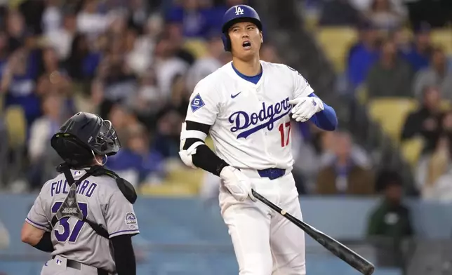 Los Angeles Dodgers' Shohei Ohtani reacts after hitting a foul ball as Colorado Rockies catcher Braxton Fulford kneels at the plate during the first inning of a baseball game Wednesday, April 16, 2025, in Los Angeles. (AP Photo/Mark J. Terrill)