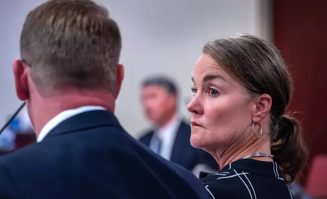 Julia Peters, center, representing the estate of actor Gene Hackman and his wife Betsy Arakawa Hackman, sits with her attorneys regarding a case that involves the release of any public records in First District Court, in Santa Fe, N.M., Monday, March 31, 2025. (Eddie Moore/The Albuquerque Journal via AP)