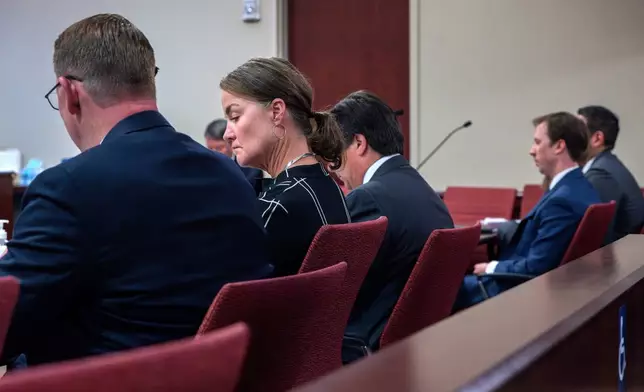 Julia Peters, center, representing the estate of actor Gene Hackman and his wife Betsy Arakawa Hackman, sits in First District Court with her attorneys during arguments for an injunction to prevent the release of photos and other evidence related to the death of the Hackmans last month, in Santa Fe, N.M., Monday, March 31, 2025. (Eddie Moore/The Albuquerque Journal via AP)