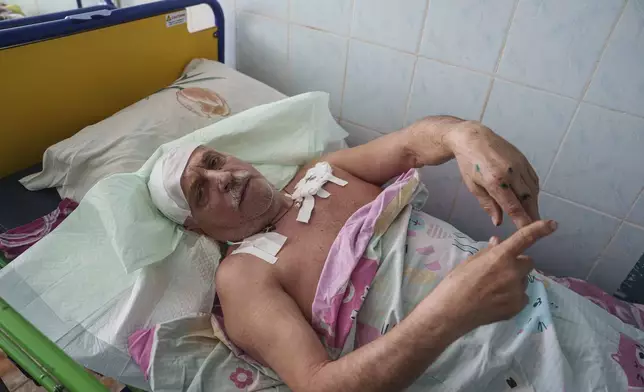Hennadii Smolarov, 73, injured in a deadly Palm Sunday Russian attack on Sumy on April 13, lies on a bed at a hospital in Sumy, Ukraine,Tuesday, April 15, 2025. (AP Photo/Evgeniy Maloletka)