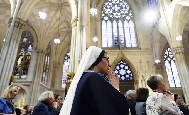 Parishioners pray during a mass for Pope Francis at St. Patrick's Cathedral, Tuesday, April 22, 2025, in New York. (AP Photo/Julia Demaree Nikhinson)