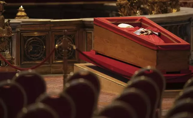 The body of Pope Francis, who will lie in state for three days, sits in St. Peter's Basilica before the doors are open to the public, at the Vatican, Wednesday, April 23, 2025. (AP Photo/Francisco Seco)