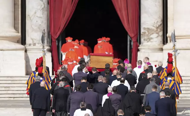 The body of Pope Francis is carried through St. Peter's Square to St. Peter's Basilica at the Vatican, Wednesday, April 23, 2025, where he will lie in state for three days. (AP Photo/Stefano Costantino)