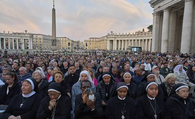 Faithful attend a rosary prayer for the late Pope Francis, in St. Peter's Square at the Vatican, Tuesday April 22, 2025. (AP Photo/Bernat Armangue)