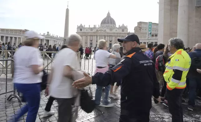 Faithful are channeled in St. Peter's Square at the Vatican, Wednesday, April 23, 2025 as the body of the late Pope Francis will lie in state inside St. Peter's Basilica for three days. (AP Photo/Markus Schreiber)