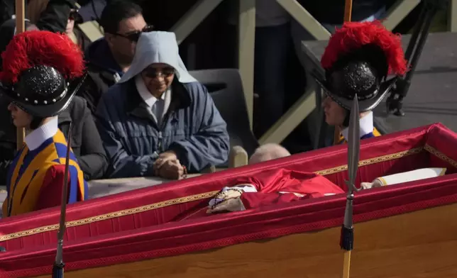 The ceremony with the Pope Francis' body, who will lie in state at St. Peter's Basilica for three days, pass through the crowd at the Vatican, Wednesday, April 23, 2025. (AP Photo/Gregorio Borgia)