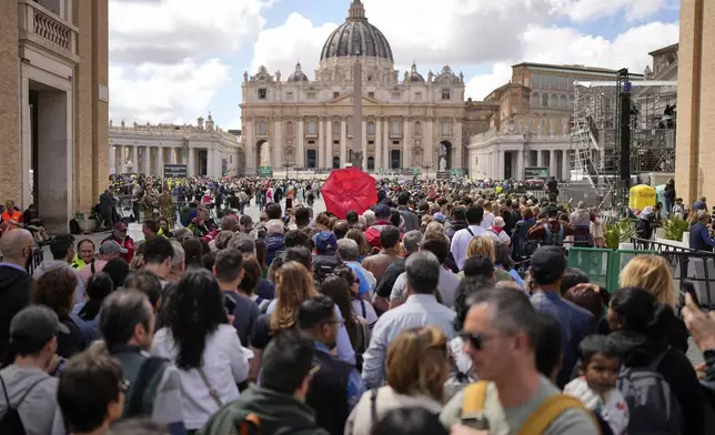 People wait in St. Peter's Square to pay their respects to the late Pope Francis, lying in state at St. Peter's Basilica for the final day, at the Vatican, Friday, April 25, 2025. (AP Photo/Andreea Alexandru)