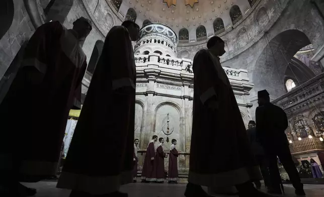 Christian pilgrims and clergymen participate in the Easter Sunday Mass at the Church of the Holy Sepulcher, the site where according to tradition Jesus was crucified and buried, in Jerusalem's Old City, Sunday, April 20, 2025. (AP Photo/Mahmoud Illean)