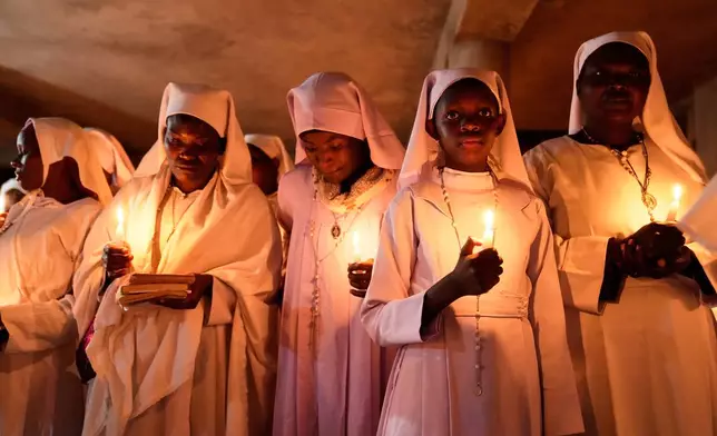 Christian faithful of the Legio Maria African Mission, attend the Easter vigil Mass in the informal settlement of Kibera in Nairobi, Kenya, Saturday, April 19, 2025. (AP Photo/Brian Inganga)
